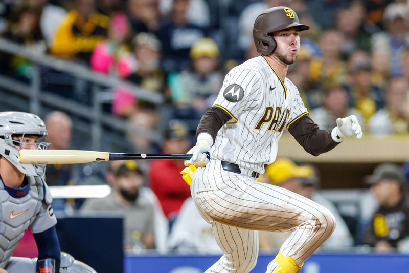 Mar 27, 2026; San Diego, California, USA; San Diego Padres center fielder Jackson Merrill (3) hits an infield single during the fourth inning against the Detroit Tigers at Petco Park. Mandatory Credit: David Frerker-Imagn Images