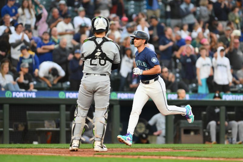 Jun 10, 2024; Seattle, Washington, USA; Seattle Mariners right fielder Dominic Canzone (8) crosses home plate after hitting a home run against the Chicago White Sox during the eighth inning at T-Mobile Park. Mandatory Credit: Steven Bisig-USA TODAY Sports