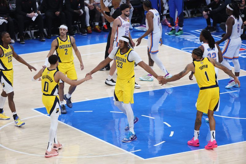OKLAHOMA CITY, OK - JUNE 5:Myles Turner #33 high fives Tyrese Haliburton #0 and Obi Toppin #1 of the Indiana Pacers during the game against the Oklahoma City Thunder during Game 1 of the 2025 NBA Finals on June 5, 2025 at Paycom Center in Oklahoma City, Oklahoma. NOTE TO USER: User expressly acknowledges and agrees that, by downloading and or using this photograph, User is consenting to the terms and conditions of the Getty Images License Agreement. Mandatory Copyright Notice: Copyright 2025 NBAE (Photo by Joe Murphy/NBAE via Getty Images)