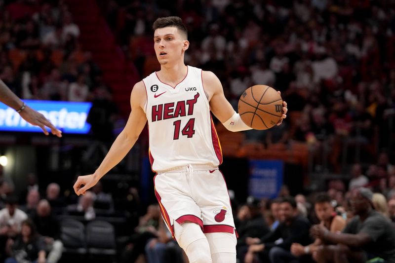 MIAMI, FL - APRIL 1:  Tyler Herro #14 of the Miami Heat dribbles the ball against the Dallas Mavericks on April 1, 2023 at FTX Arena in Miami, Florida. NOTE TO USER: User expressly acknowledges and agrees that, by downloading and or using this Photograph, user is consenting to the terms and conditions of the Getty Images License Agreement. Mandatory Copyright Notice: Copyright 2023 NBAE (Photo by Issac Baldizon/NBAE via Getty Images)