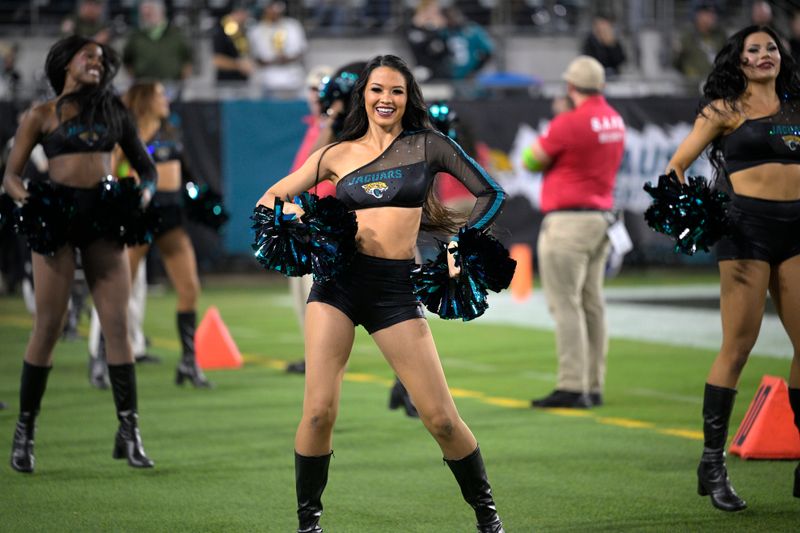 Jacksonville Jaguars cheerleaders perform on the sideline during the second half of an NFL football game against the Cincinnati Bengals, Monday, Dec. 4, 2023, in Jacksonville, Fla. (AP Photo/Phelan M. Ebenhack)