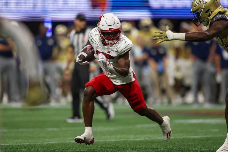 Sep 1, 2023; Atlanta, Georgia, USA; Louisville Cardinals running back Maurice Turner (4) runs the ball against the Georgia Tech Yellow Jackets in the second half at Mercedes-Benz Stadium. Mandatory Credit: Brett Davis-USA TODAY Sports