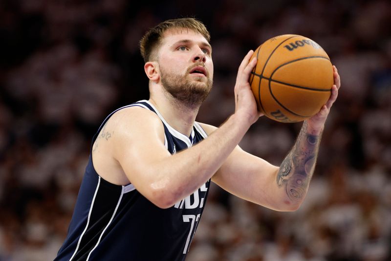 MINNEAPOLIS, MINNESOTA - MAY 22: Luka Doncic #77 of the Dallas Mavericks shoots a free throw during the fourth quarter against the Minnesota Timberwolves in Game One of the Western Conference Finals at Target Center on May 22, 2024 in Minneapolis, Minnesota. NOTE TO USER: User expressly acknowledges and agrees that, by downloading and or using this photograph, User is consenting to the terms and conditions of the Getty Images License Agreement. (Photo by David Berding/Getty Images)