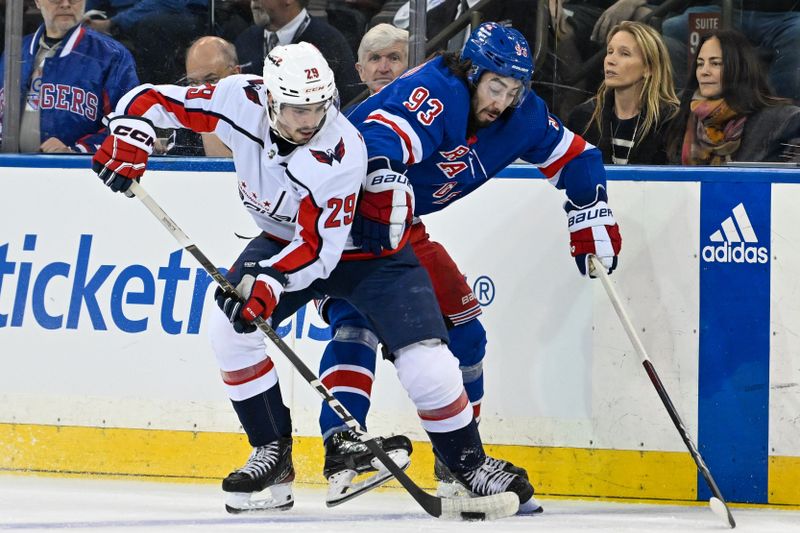 Apr 23, 2024; New York, New York, USA;  Washington Capitals center Hendrix Lapierre (29) and New York Rangers center Mika Zibanejad (93) battle for the puck during the first period in game two of the first round of the 2024 Stanley Cup Playoffs at Madison Square Garden. Mandatory Credit: Dennis Schneidler-USA TODAY Sports