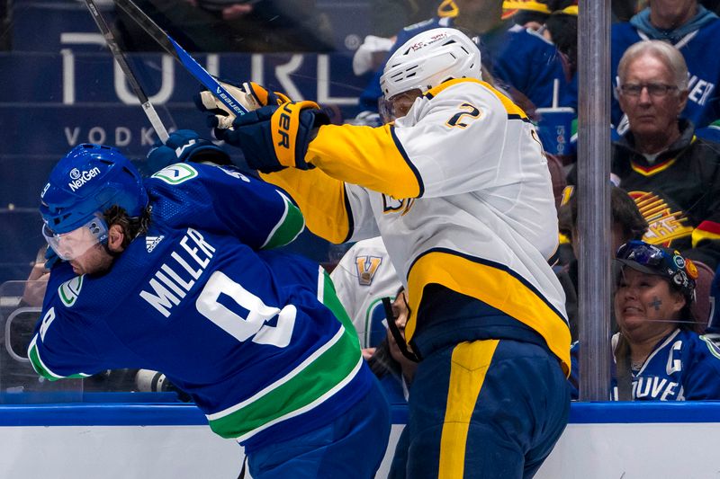 Apr 23, 2024; Vancouver, British Columbia, CAN; Vancouver Canucks forward J.T. Miller (9) checks Nashville Predators defenseman Luke Schenn (2) during the first period in game two of the first round of the 2024 Stanley Cup Playoffs at Rogers Arena. Mandatory Credit: Bob Frid-USA TODAY Sports