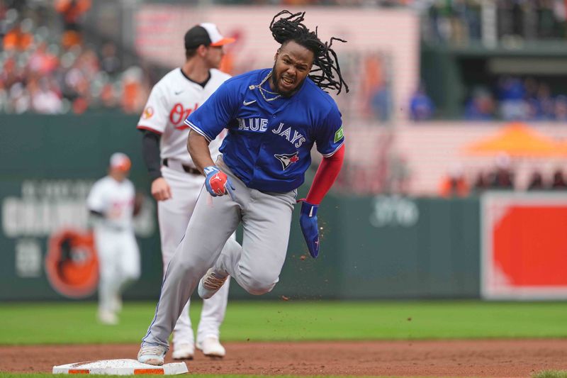 May 15, 2024; Baltimore, Maryland, USA; Toronto Blue Jays first baseman Vladimir Guerrero Jr. (27) rounds third base to score in the third inning against the Baltimore Orioles at Oriole Park at Camden Yards. Mandatory Credit: Mitch Stringer-USA TODAY Sports