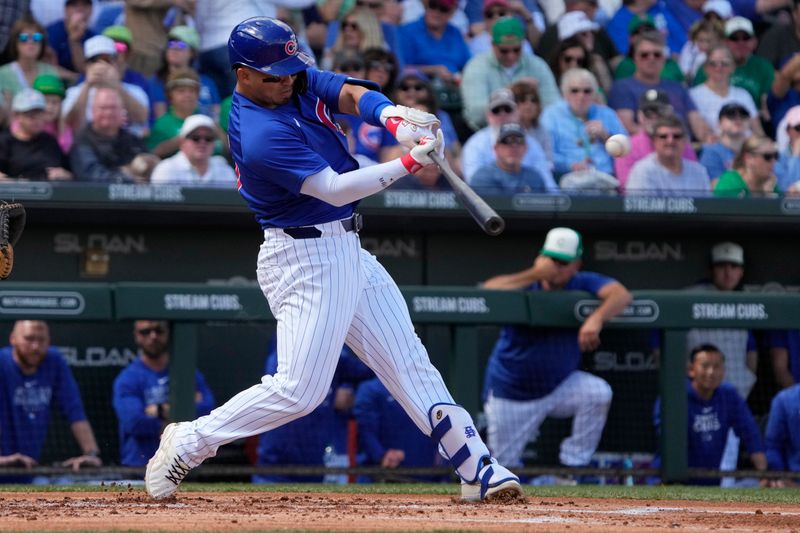 Mar 17, 2024; Mesa, Arizona, USA; Chicago Cubs right fielder Seiya Suzuki (27) hits a double against the Texas Rangers in the first inning at Sloan Park. Mandatory Credit: Rick Scuteri-USA TODAY Sports