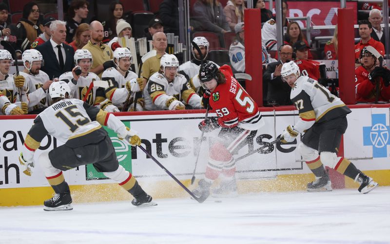 Jan 4, 2026; Chicago, Illinois, USA; Chicago Blackhawks left wing Tyler Bertuzzi (59), Vegas Golden Knights defenseman Noah Hanifin (15) and defenseman Ben Hutton (17) battle for control of the puck during the first period at United Center. Mandatory Credit: Talia Sprague-Imagn Images