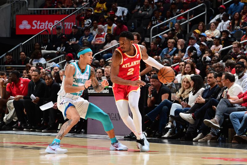 ATLANTA, GA - APRIL 10: Trent Forrest #2 of the Atlanta Hawks handles the ball against Tre Mann #23 of the Charlotte Hornets during the game on April 10, 2024 at State Farm Arena in Atlanta, Georgia.  NOTE TO USER: User expressly acknowledges and agrees that, by downloading and/or using this Photograph, user is consenting to the terms and conditions of the Getty Images License Agreement. Mandatory Copyright Notice: Copyright 2024 NBAE (Photo by Scott Cunningham/NBAE via Getty Images)