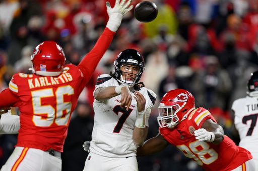 Houston Texans quarterback C.J. Stroud (7) throws while being pressured by Kansas City Chiefs defensive end George Karlaftis (56) and Chiefs defensive tackle Tershawn Wharton (98) during the second half of an NFL football divisional playoff game, Saturday, Jan. 18, 2025 in Kansas City, Mo. The Chiefs defeated the Texans by a score of 23-14. (AP Photo/Reed Hoffmann)