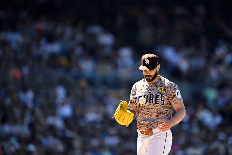 Aug 25, 2024; San Diego, California, USA; San Diego Padres relief pitcher Tanner Scott (66) tosses a ball during the eighth inning against the New York Mets at Petco Park. Mandatory Credit: Orlando Ramirez-USA TODAY Sports