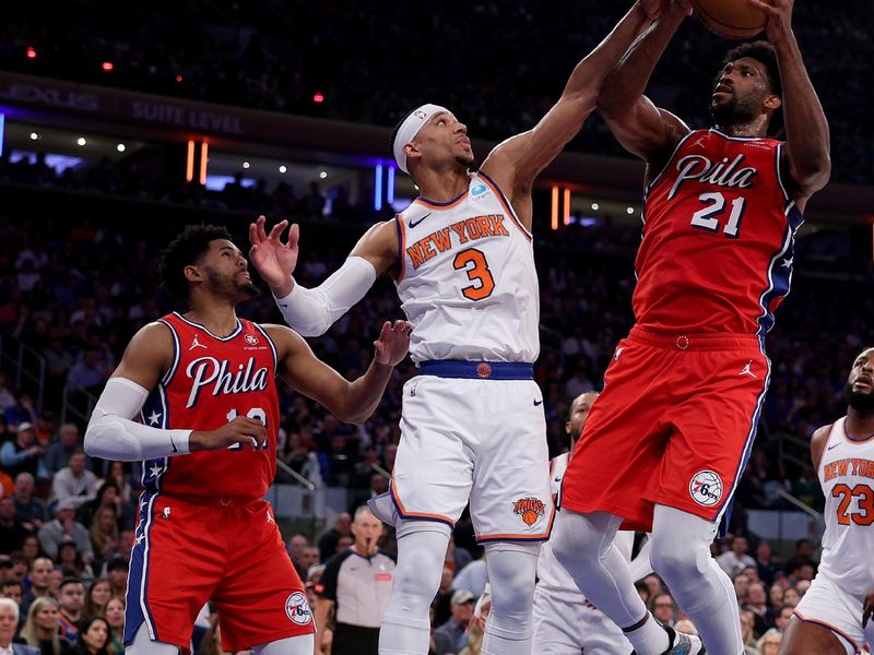 NEW YORK, NEW YORK - APRIL 20: Joel Embiid #21 of the Philadelphia 76ers heads for the net as Josh Hart #3 of the New York Knicks defends during the first half in game one of the Eastern Conference First Round Playoffs at Madison Square Garden on April 20, 2024 in New York City. NOTE TO USER: User expressly acknowledges and agrees that, by downloading and or using this photograph, User is consenting to the terms and conditions of the Getty Images License Agreement. (Photo by Elsa/Getty Images)