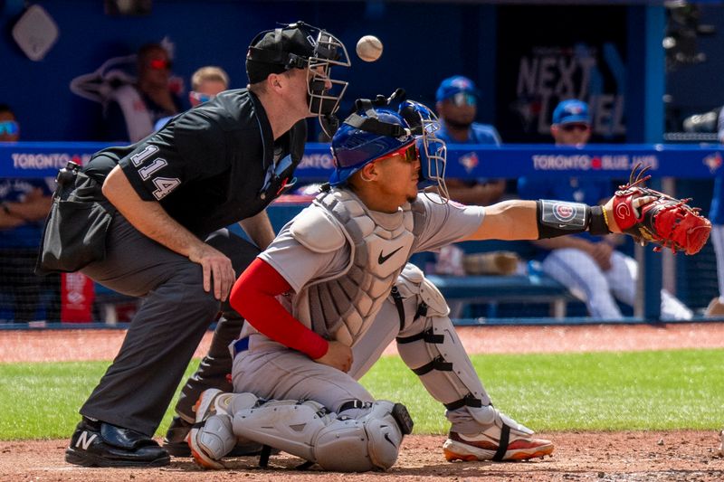 Aug 13, 2023; Toronto, Ontario, CAN; Chicago Cubs catcher Miguel Amaya (6) gets his face guard knocked off during the fourth inning at a MLB game against the Toronto Blue Jays at Rogers Centre. Mandatory Credit: Kevin Sousa-USA TODAY Sports