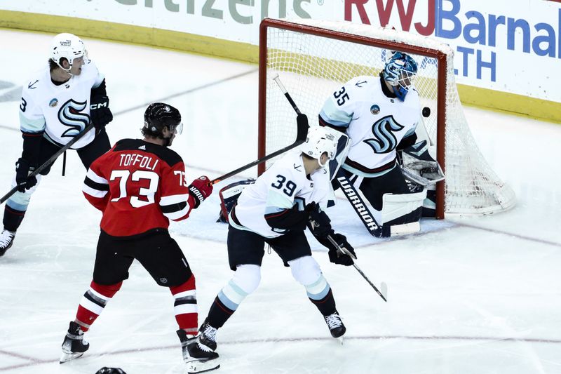 Feb 12, 2024; Newark, New Jersey, USA; Seattle Kraken goaltender Joey Daccord (35) makes a save against the New Jersey Devils during the third period at Prudential Center. Mandatory Credit: John Jones-USA TODAY Sports