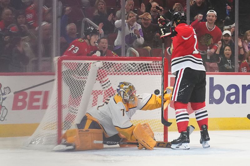 Oct 25, 2024; Chicago, Illinois, USA; Chicago Blackhawks center Craig Smith (15) scores a goal on Nashville Predators goaltender Juuse Saros (74) during the first period at the United Center. Mandatory Credit: David Banks-Imagn Images