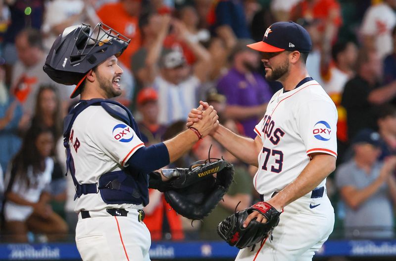 Jun 23, 2024; Houston, Texas, USA;  Houston Astros relief pitcher Luis Contreras (73) and  catcher Cesar Salazar (18) celebrates after defeating the Baltimore Orioles at Minute Maid Park. Mandatory Credit: Thomas Shea-USA TODAY Sports