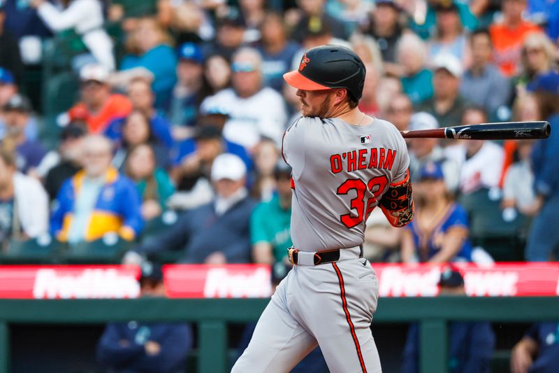 Jun 3, 2025; Seattle, Washington, USA; Baltimore Orioles first baseman Ryan O'Hearn (32) hits a single against the Seattle Mariners during the first inning at T-Mobile Park. Mandatory Credit: Joe Nicholson-Imagn Images