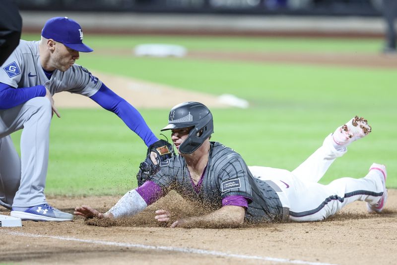 May 24, 2025; New York City, New York, USA;  New York Mets first baseman Pete Alonso (20) is tagged out by Los Angeles Dodgers first baseman Freddie Freeman (5) on a pick off play in the seventh inning  at Citi Field. Mandatory Credit: Wendell Cruz-Imagn Images