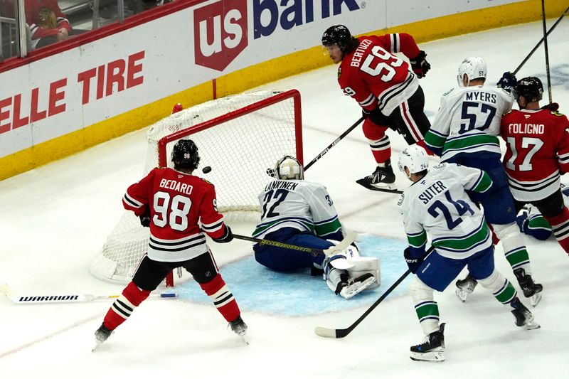 Oct 22, 2024; Chicago, Illinois, USA; Chicago Blackhawks left wing Tyler Bertuzzi (59) scores a goal on Vancouver Canucks goaltender Kevin Lankinen (32) during the third period at United Center. Mandatory Credit: David Banks-Imagn Images