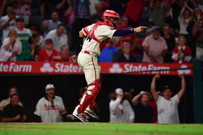 Aug 18, 2023; Anaheim, California, USA; Los Angeles Angels catcher Logan O'Hoppe (14) reacts after tagging out Tampa Bay Rays first baseman Yandy Diaz (2) at home during the ninth inning at Angel Stadium. Mandatory Credit: Gary A. Vasquez-USA TODAY Sports