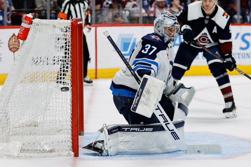 Apr 13, 2024; Denver, Colorado, USA; Winnipeg Jets goaltender Connor Hellebuyck (37) deflects a shot in the second period against the Colorado Avalanche at Ball Arena. Mandatory Credit: Isaiah J. Downing-USA TODAY Sports