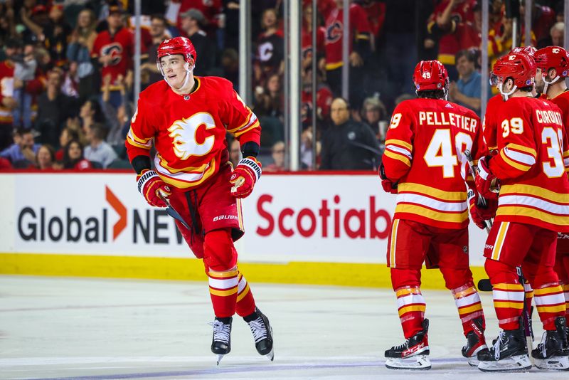 Apr 12, 2023; Calgary, Alberta, CAN; Calgary Flames defenseman Nikita Zadorov (16) celebrates his goal with teammates against the San Jose Sharks during the third period at Scotiabank Saddledome. Mandatory Credit: Sergei Belski-USA TODAY Sports