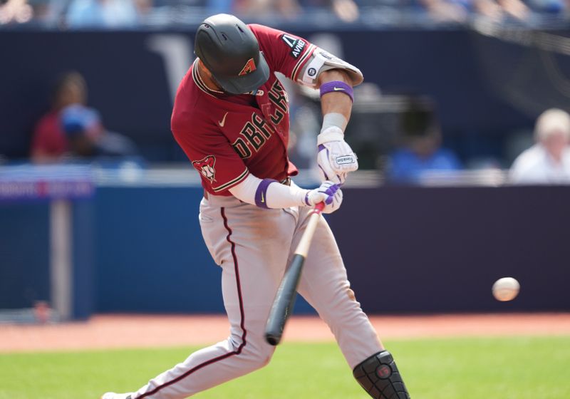 Jul 16, 2023; Toronto, Ontario, CAN; Arizona Diamondbacks left fielder Lourdes Gurriel Jr. (12) hits a single against the Toronto Blue Jays during the eighth inning at Rogers Centre. Mandatory Credit: Nick Turchiaro-USA TODAY Sports