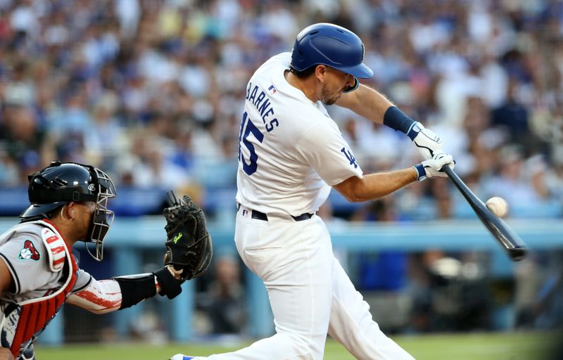 Jul 4, 2024; Los Angeles, California, USA; Los Angeles Dodgers catcher Austin Barnes (15) hits a two-RBI single during the fourth inning against the Arizona Diamondbacks at Dodger Stadium. Mandatory Credit: Jason Parkhurst-USA TODAY Sports