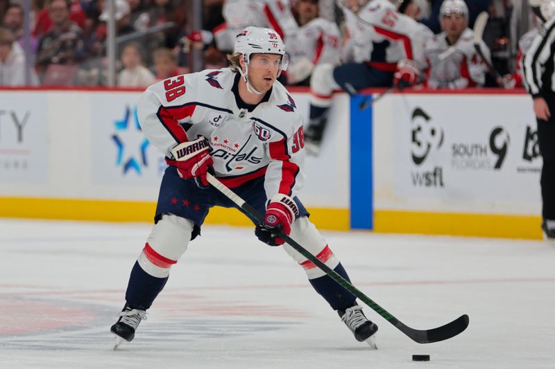 Nov 25, 2024; Sunrise, Florida, USA; Washington Capitals defenseman Rasmus Sandin (38) moves the puck against the Florida Panthers during the first period at Amerant Bank Arena. Mandatory Credit: Sam Navarro-Imagn Images