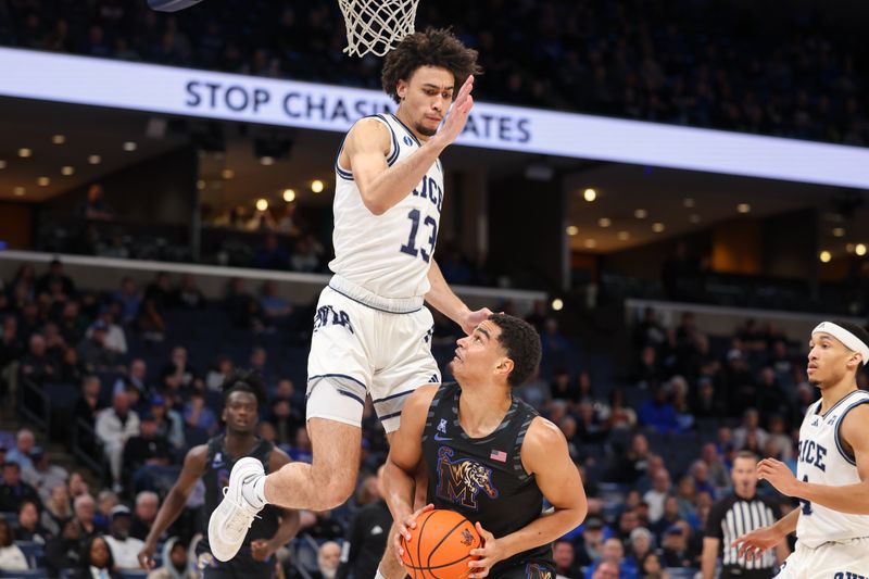 Feb 26, 2025; Memphis, Tennessee, USA; Memphis Tigers forward Nicholas Jourdain (2) handles the ball as Rice Owls forward Andrew Akuchie (13) defends during the first half at FedExForum. Mandatory Credit: Wesley Hale-Imagn Images