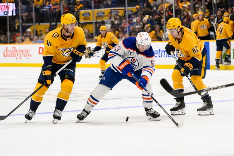 Oct 31, 2024; Nashville, Tennessee, USA;  Edmonton Oilers center Jeff Skinner (53) controls the puck against Nashville Predators center Colton Sissons (10) and center Tommy Novak (82) during the second period at Bridgestone Arena. Mandatory Credit: Steve Roberts-Imagn Images