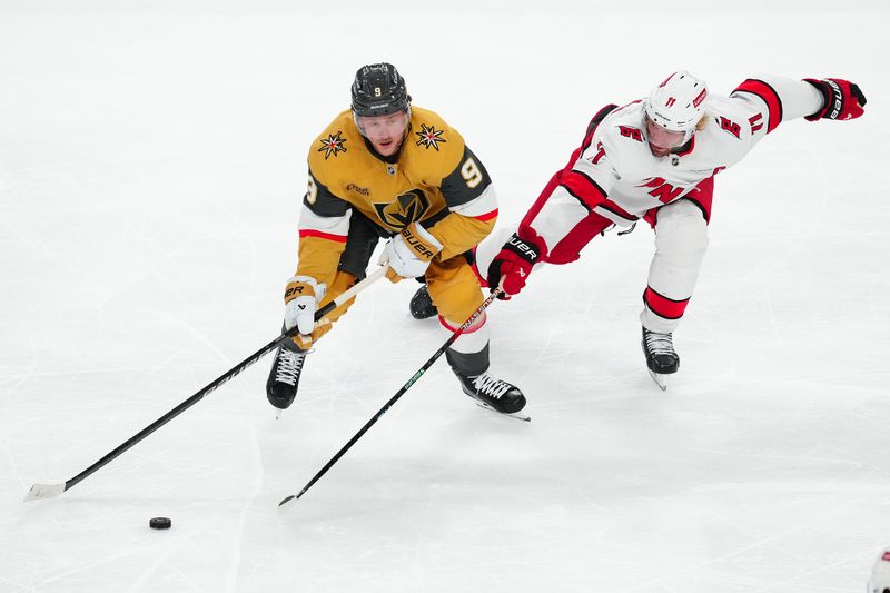 Nov 11, 2024; Las Vegas, Nevada, USA; Vegas Golden Knights center Jack Eichel (9) is stick checked by Carolina Hurricanes center Jordan Staal (11) during the third period at T-Mobile Arena. Mandatory Credit: Stephen R. Sylvanie-Imagn Images