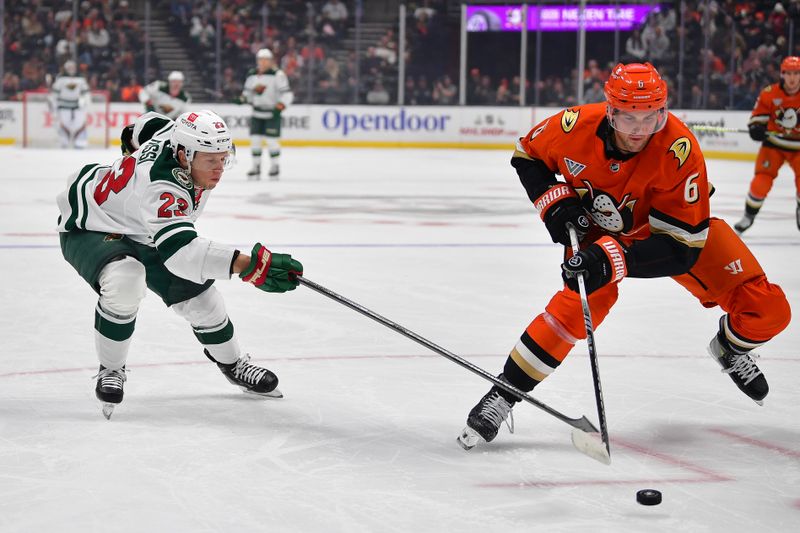 Dec 6, 2024; Anaheim, California, USA; Minnesota Wild center Marco Rossi (23) plays for the puck against Anaheim Ducks defenseman Brian Dumoulin (6) during the first period at Honda Center. Mandatory Credit: Gary A. Vasquez-Imagn Images