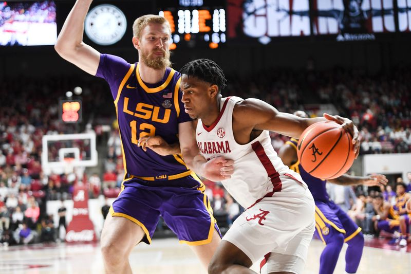 Jan 27, 2024; Tuscaloosa, Alabama, USA;   LSU forward Hunter Dean (12) defends as Alabama forward Mouhamed Dioubate (10) drives along the b baseline at Coleman Coliseum. Alabama defeated LSU 109-88. Mandatory Credit: Gary Cosby Jr.-USA TODAY Sports