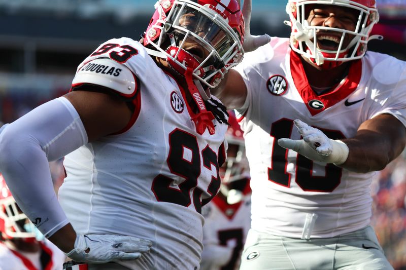 Oct 28, 2023; Jacksonville, Florida, USA; Georgia Bulldogs defensive lineman Tyrion Ingram-Dawkins (93) celebrates with linebacker Jamon Dumas-Johnson (10) after forcing a fumble by the Florida Gators during the first half at EverBank Stadium. Mandatory Credit: Kim Klement Neitzel-USA TODAY Sports