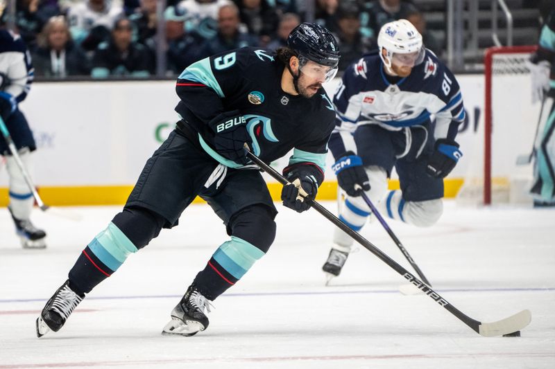 Oct 24, 2024; Seattle, Washington, USA;  Seattle Kraken forward Chandler Stephenson (9) skates with the puck during the third period against the Winnipeg Jets at Climate Pledge Arena. Mandatory Credit: Stephen Brashear-Imagn Images