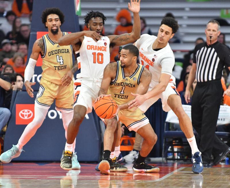 Feb 28, 2023; Syracuse, New York, USA; Georgia Tech Yellow Jackets guard Kyle Sturdivant (1) is pressured by Syracuse Orange center Jesse Edwards (14) and guard Symir Torrence (10) in the second half at the JMA Wireless Dome. Mandatory Credit: Mark Konezny-USA TODAY Sports