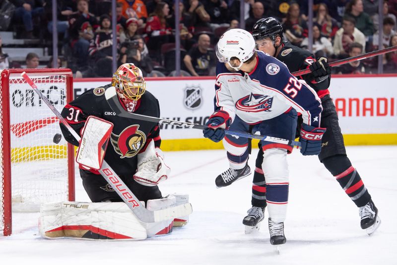 Feb 13, 2024; Ottawa, Ontario, CAN; Ottawa Senators goalie Anton Forsberg (31) makes a save in front of Columbus Blue Jackets right wing Emil Bemstrom (52) in the second period at the Canadian Tire Centre. Mandatory Credit: Marc DesRosiers-USA TODAY Sports