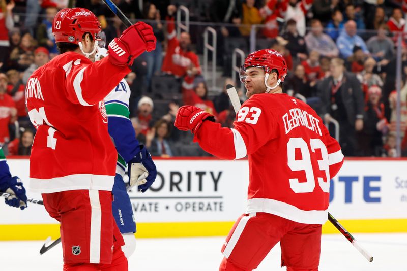 Dec 1, 2024; Detroit, Michigan, USA;  Detroit Red Wings right wing Alex DeBrincat (93) receives congratulations from center Dylan Larkin (71) after scoring in the second period against the Vancouver Canucks at Little Caesars Arena. Mandatory Credit: Rick Osentoski-Imagn Images