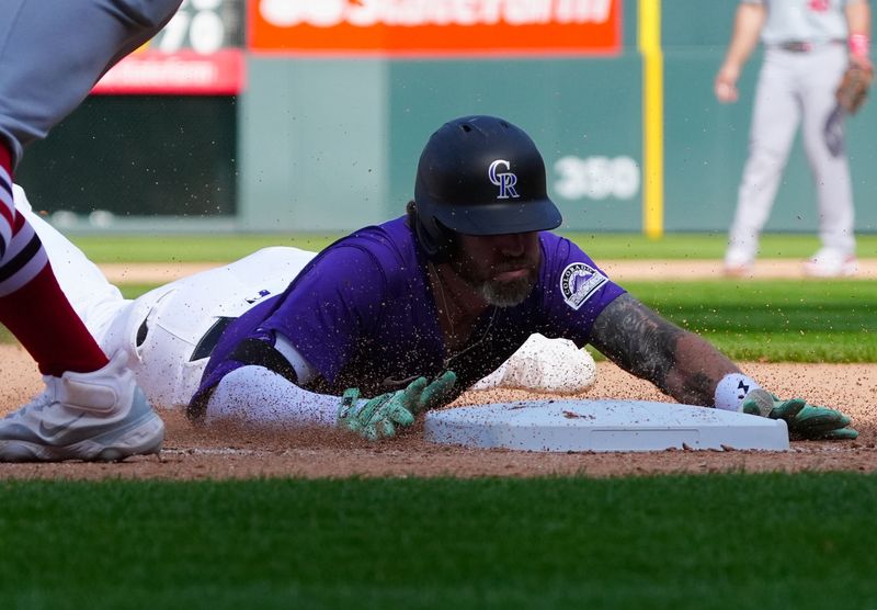 Sep 26, 2024; Denver, Colorado, USA; Colorado Rockies outfielder Jake Cave (11) slides for a triple in the eighth inning against the St. Louis Cardinals at Coors Field. Mandatory Credit: Ron Chenoy-Imagn Images