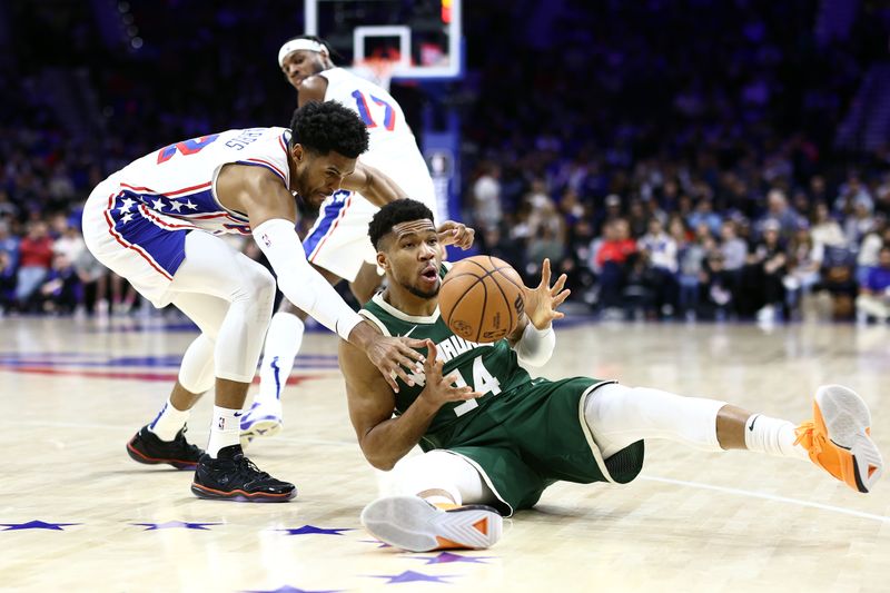 PHILADELPHIA, PENNSYLVANIA - FEBRUARY 25: Tobias Harris #12 of the Philadelphia 76ers and Giannis Antetokounmpo #34 of the Milwaukee Bucks challenge for the ball during the third quarter at the Wells Fargo Center on February 25, 2024 in Philadelphia, Pennsylvania. (Photo by Tim Nwachukwu/Getty Images)