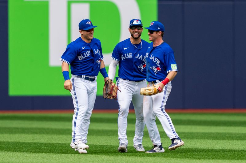 Jul 20, 2023; Toronto, Ontario, CAN; Toronto Blue Jays left fielder Daulton Varsho (25), center fielder Kevin Kiermaier (39) and left fielder Jordan Luplow (7) celebrate after defeating the San Diego Padres at Rogers Centre. Mandatory Credit: Kevin Sousa-USA TODAY Sports