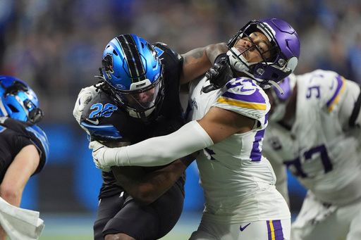 Detroit Lions running back Jahmyr Gibbs (26) runs against Minnesota Vikings safety Camryn Bynum (24) for a touchdown during the second half of an NFL football game Sunday, Jan. 5, 2025, in Detroit. (AP Photo/Charlie Riedel)