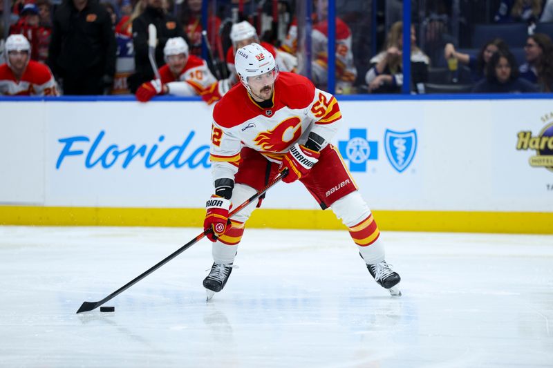Nov 26, 2025; Tampa, Florida, USA; Calgary Flames defenseman Mackenzie Weegar (52) controls the puck against the Tampa Bay Lightning in the second period at Benchmark International Arena. Mandatory Credit: Nathan Ray Seebeck-Imagn Images