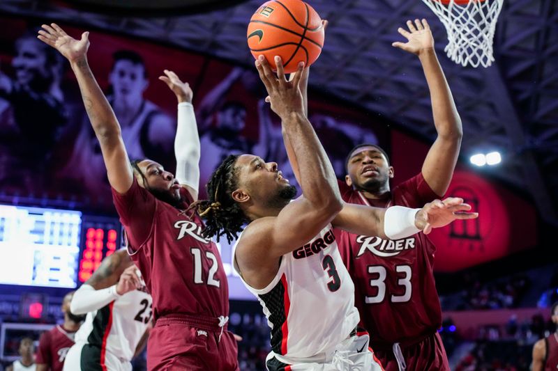 Dec 28, 2022; Athens, Georgia, USA; Georgia Bulldogs guard Kario Oquendo (3) shoots over Rider Broncs forward Tariq Ingraham (33) during the first half at Stegeman Coliseum. Mandatory Credit: Dale Zanine-USA TODAY Sports