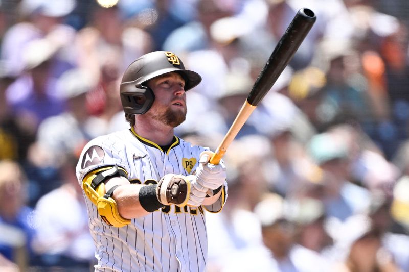 August 14, 2024; San Diego, California, USA; San Diego Padres first base Jake Cronenworth (9) hits a three run home run against the Pittsburgh Pirates during the first inning at Petco Park. Mandatory Credit: Denis Poroy-USA TODAY Sports at Petco Park. 