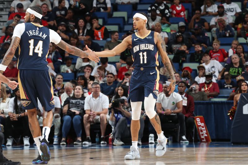 NEW ORLEANS, LA - NOVEMBER 6: Brandon Ingram #14 and Jalen Crutcher #11 of the New Orleans Pelicans high five during the game against the Cleveland Cavaliers on November 6, 2024 at the Smoothie King Center in New Orleans, Louisiana. NOTE TO USER: User expressly acknowledges and agrees that, by downloading and or using this Photograph, user is consenting to the terms and conditions of the Getty Images License Agreement. Mandatory Copyright Notice: Copyright 2024 NBAE (Photo by Layne Murdoch Jr./NBAE via Getty Images)