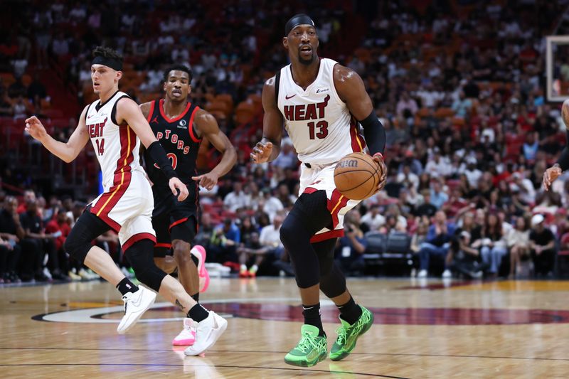 MIAMI, FLORIDA - APRIL 14: Bam Adebayo #13 of the Miami Heat dribbles the ball against the Toronto Raptors during the first quarter of the game at Kaseya Center on April 14, 2024 in Miami, Florida. NOTE TO USER: User expressly acknowledges and agrees that, by downloading and or using this photograph, User is consenting to the terms and conditions of the Getty Images License Agreement. (Photo by Megan Briggs/Getty Images)