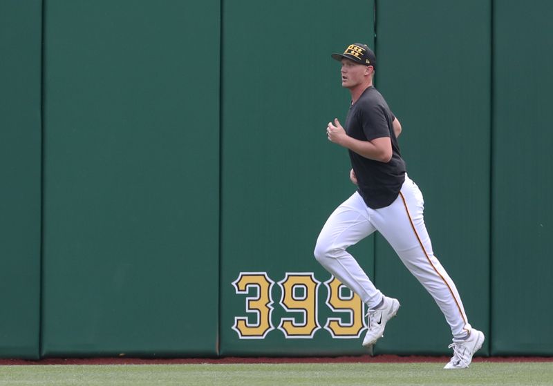 May 21, 2025; Pittsburgh, Pennsylvania, USA;  Pittsburgh Pirates pitcher Mitch Keller (23) runs in the outfield before the game against the Cincinnati Reds at PNC Park. Mandatory Credit: Charles LeClaire-Imagn Images