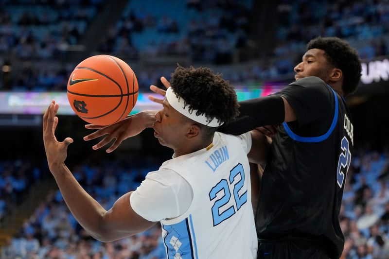 Jan 7, 2025; Chapel Hill, North Carolina, USA; North Carolina Tar Heels forward Ven-Allen Lubin (22) and Southern Methodist Mustangs forward Jerrell Colbert (20) fight for the ball in the first half at Dean E. Smith Center. Mandatory Credit: Bob Donnan-Imagn Images